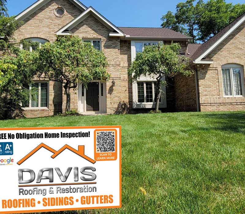Brick home front yard with Davis Roofing sign out front